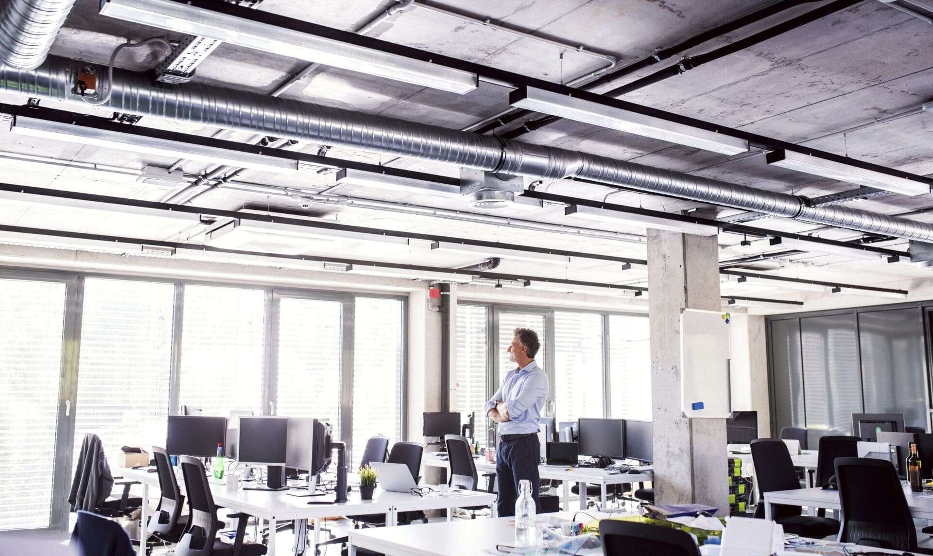 Businessman standing in an empty open plan office