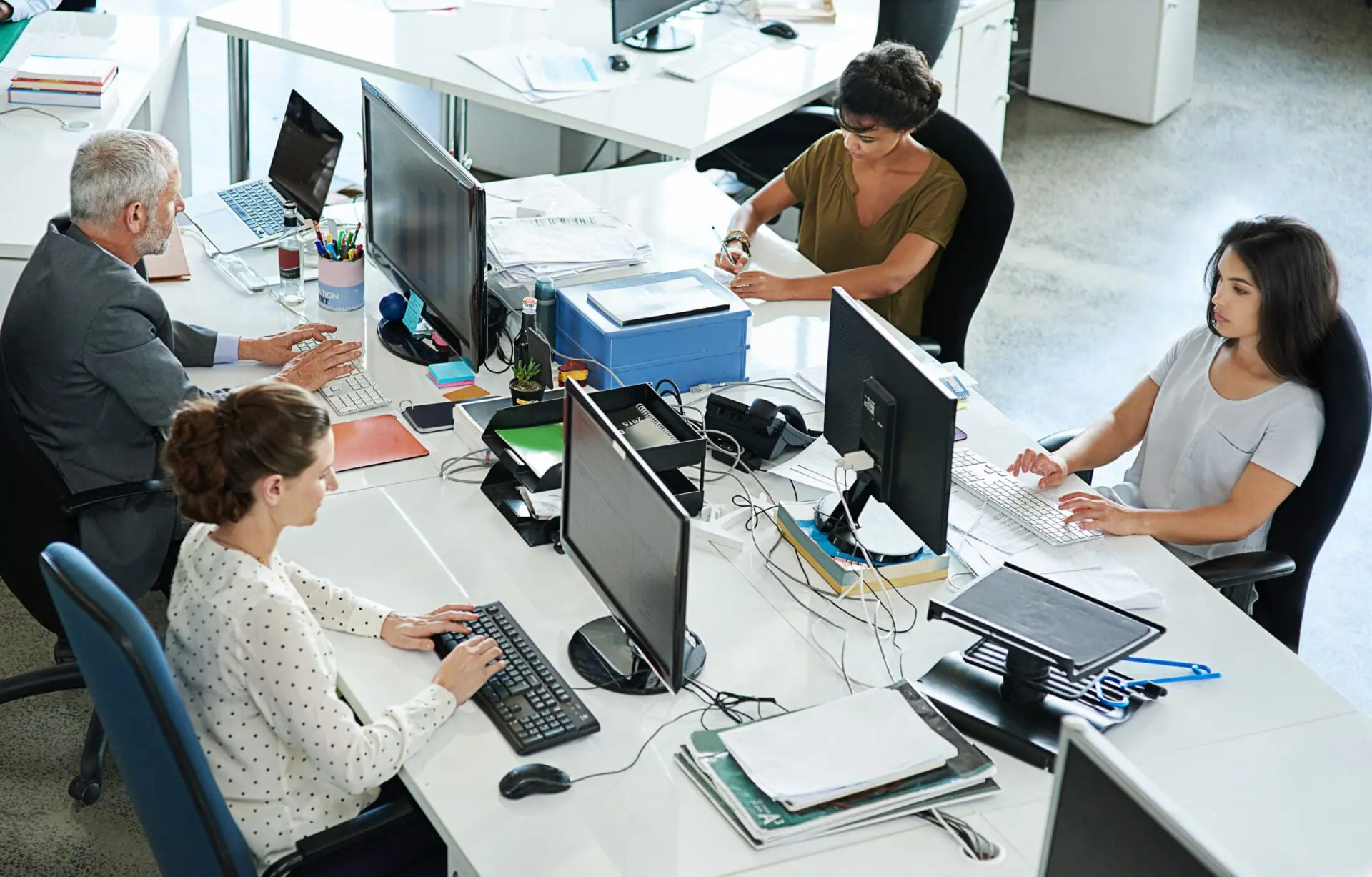 Shot of a group of coworkers sitting at their workstations in an office.